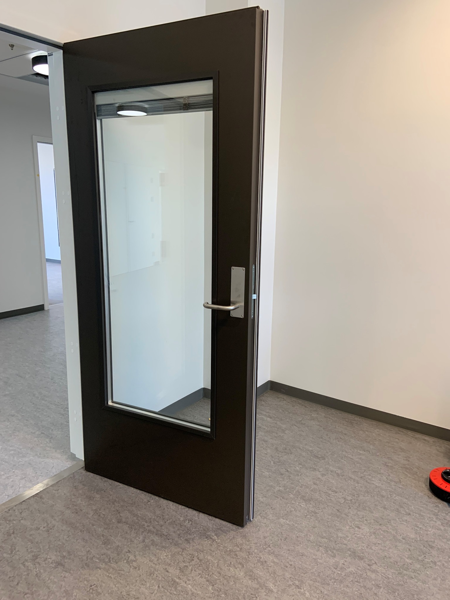 Interior door with glazed vision panel and integrated blind